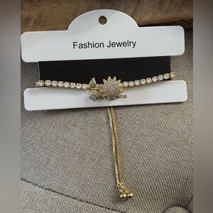 Gold tone rhinestone adjustable bracelet. Beautiful flower on top spins. NWT
